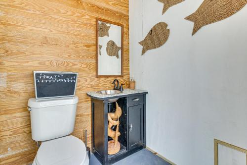 a bathroom with a toilet and a sink at Waterfront Port Isabel Family Home with Pool and Pier! in Port Isabel