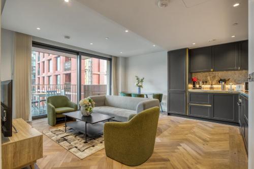 a living room with a couch and a table at Hyde Park Luxury 2BR 2BA Balcony in London
