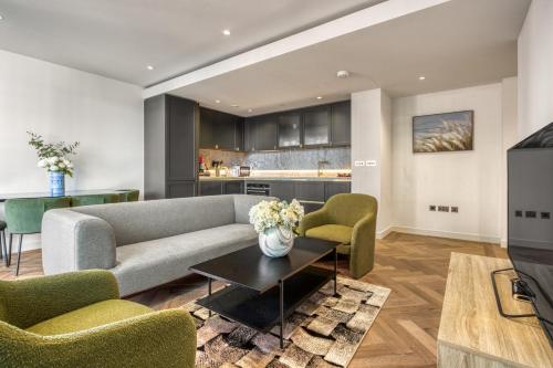 a living room with a couch and chairs and a table at Hyde Park Luxury 2BR 2BA Balcony in London