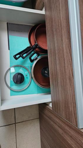 a drawer with pots and pans in a cabinet at Apartamento zona Norte Ucebol in Santa Cruz de la Sierra