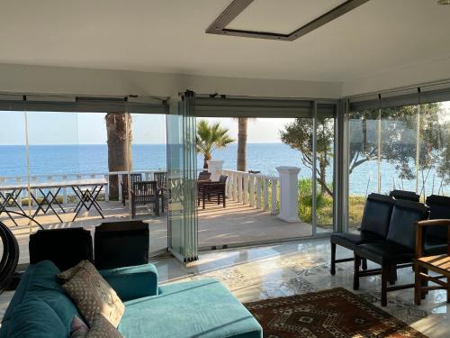 a living room with a couch and a view of the ocean at ZBB Villa & Bungalow in Alanya