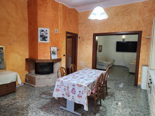 a dining room with a table and a fireplace at Three bedroom Entire place in Roseto degli Abruzzi