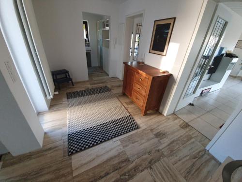 a hallway with a wooden dresser in a house at Home&Castle in Steinenbronn