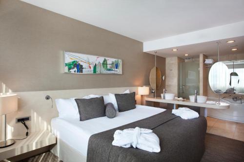 a hotel room with a large bed and a bathroom at CPAnkara Hotel in Ankara