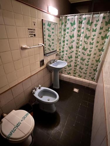 a bathroom with a toilet and a sink at Motel Cocovi in Ciudad Lujan de Cuyo