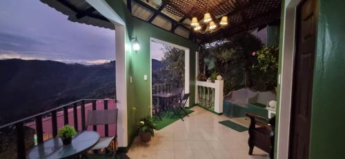 a balcony of a house with a view of the mountains at Hotel El Tambor OASIS Antigua Guatemala in Antigua Guatemala