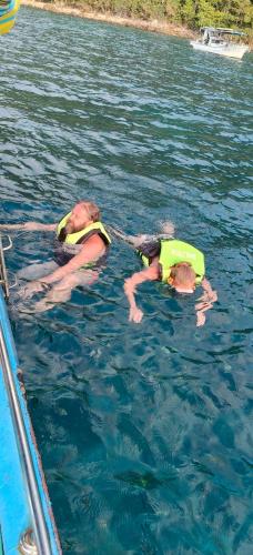 two people in the water in the water at Yuyu Golden Beach in Ko Chang