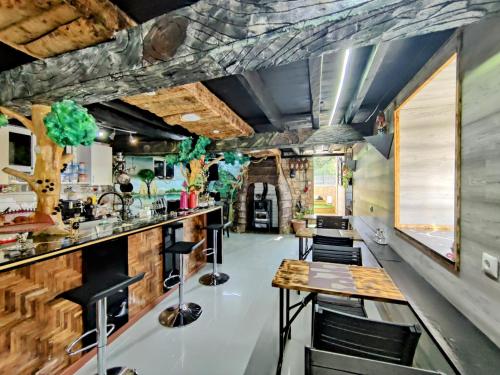 a room with a bar and tables and chairs at Família 12-Casa Amazonia PT in Cernache