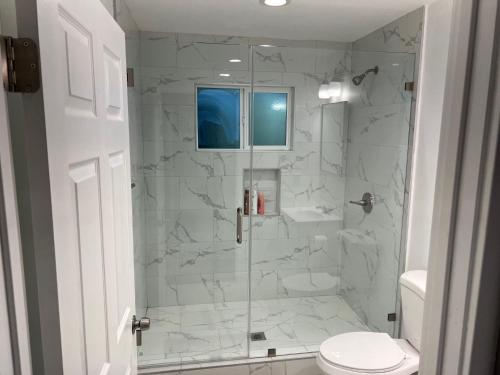 a bathroom with a glass shower with a toilet at Private gated 1bed & 1bath amazing for 2 in Los Angeles near Universal studio & Hollywood in Van Nuys Airport