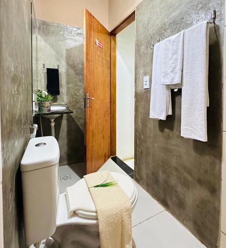 a bathroom with a toilet and a sink at Pousada Zoom Jericoacoara in Jericoacoara