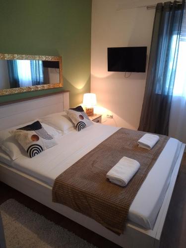 a bedroom with a large bed with two towels on it at Apartment Pag 6412c in Pag