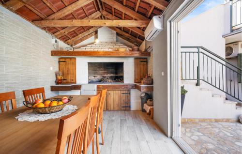 a kitchen with a table with a bowl of fruit at 2 Bedroom Gorgeous Apartment In Vezac in Vezac