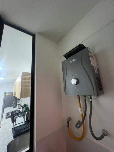 a soap dispenser in a room with a window at AMPLIO DEPARTAMENTO EN JESÚS MARÍa in Lima