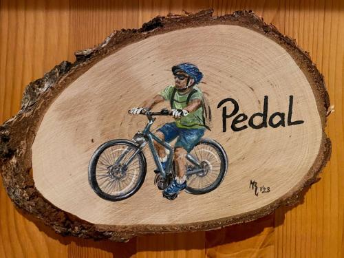a picture of a man riding a bike on a wooden board at Schumacher's Landhaus - Bücherhotel in Friedeburg
