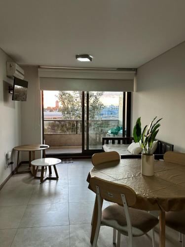 a room with a table and chairs and a large window at Departamento Condominio del Alto 3 H&L in Rosario