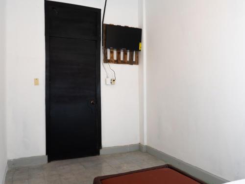 a room with a black door and a red rug at La Vieja Habana Zona Colonial in Santo Domingo