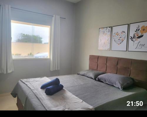 a bedroom with a large bed with blue towels on it at Dunas residence casa 15- Lençois Maranhense in Santo Amaro