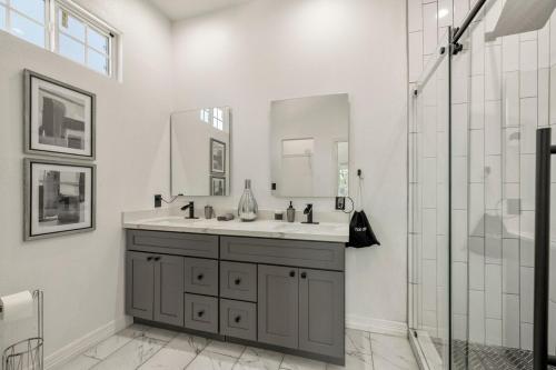 a bathroom with a sink and a shower at Modern and Serene Oasis Mins from Downtown Houston in Houston