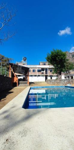 a swimming pool in front of a building at Hostal 38 in Tepoztlán