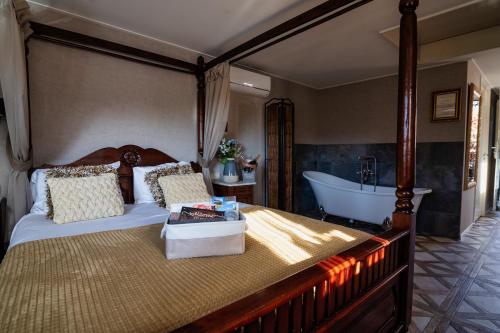 a bedroom with a bed and a bath tub at Hotel het Rietershuijs in Kalenberg