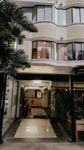 a building with a hallway in front of it at Hotel Balcones del Estadio in Medellín