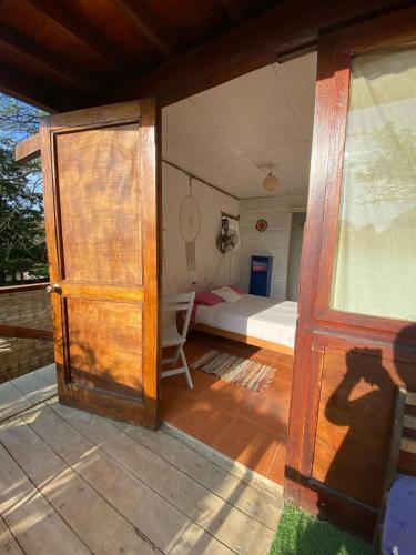 an open door to a bedroom with a bed at Wiracocha Hostal Máncora in Máncora