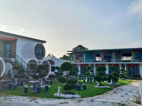 a cemetery in front of a building at Olly de Home Ent in Batu Gajah
