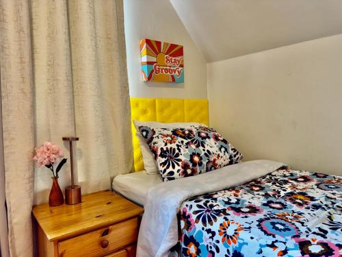 a small bedroom with a bed and a vase of flowers at Private room with two twin beds air conditioning and shared bathrooms located near SeaTac Airport and Downtown Seattle in Seattle