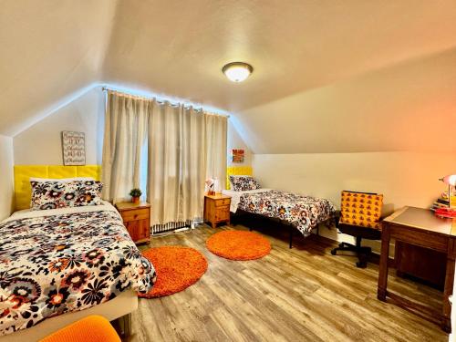 a bedroom with two beds and a desk at Private room with two twin beds air conditioning and shared bathrooms located near SeaTac Airport and Downtown Seattle in Seattle