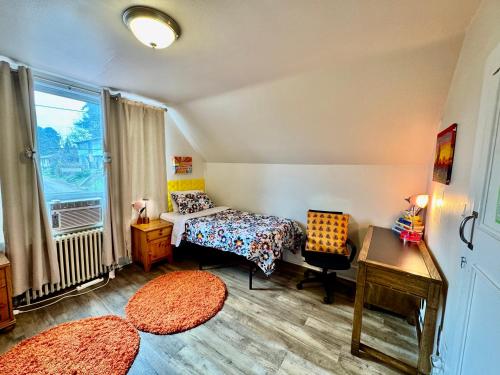 a bedroom with a bed and a desk and a window at Private room with two twin beds air conditioning and shared bathrooms located near SeaTac Airport and Downtown Seattle in Seattle