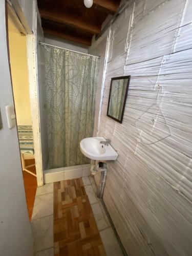 a bathroom with a sink and a shower at Wiracocha Hostal Máncora in Máncora