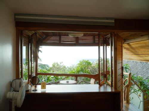 a room with a window with a view of the ocean at Tantawan sea view residence 山海居 in Salad Beach