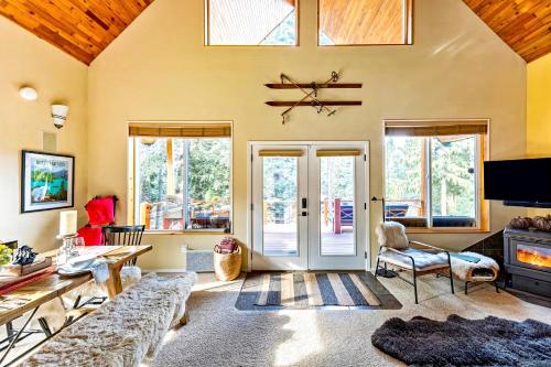 a living room with a couch and a table at Riverfront Chalet Near Skiing, Lakes, Mtns & Leavenworth in Leavenworth