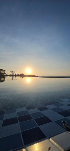 a view of the sun setting over the water at Long Vĩ hotel - đảo Phú Quý in Cu Lao Thu