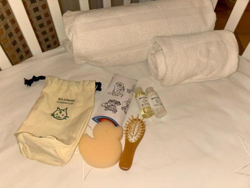a bed with towels and toilet paper and a toothbrush at Sercotel Toledo Renacimiento in Toledo