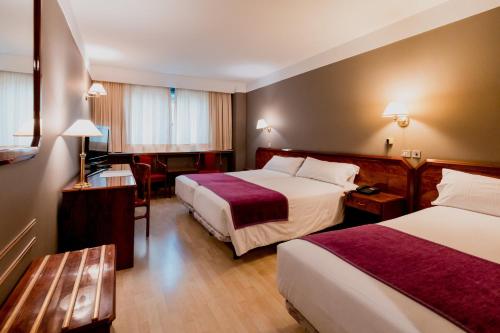Ένα ή περισσότερα κρεβάτια σε δωμάτιο στο Sercotel Delfos Andorra