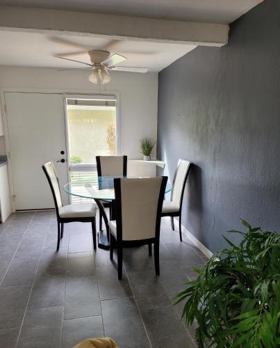 a dining room with a glass table and chairs at Entire 2 level townhouse in Old Town Scottsdale! in Scottsdale