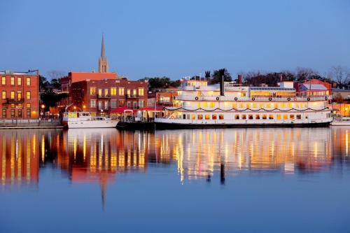 a large boat is docked in the water with buildings at Staybridge Suites Wilmington East by IHG in Wilmington