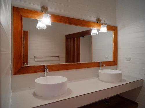 two sinks in a bathroom with a large mirror at Tantawan sea view residence 山海居 in Salad Beach