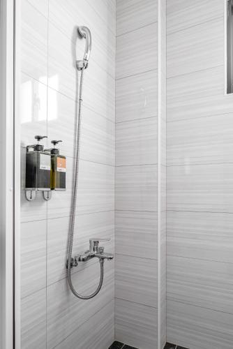 a shower in a bathroom with a glass door at Penghu Lemongrass in Magong