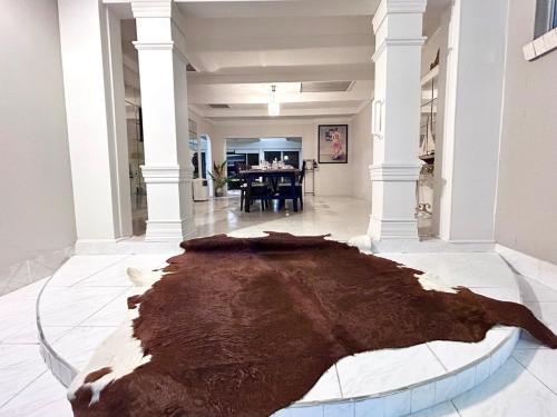 a large brown rug on the floor of a room at Charming Chevron Island Haven- Dog-Friendly Retreat Right on Main River in Gold Coast