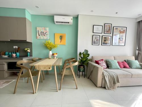 a living room with a couch and a table at The Sóng Vũng Tàu Escape Apartment in Vung Tau