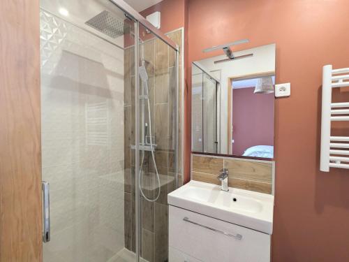 a bathroom with a shower and a sink and a mirror at Studio calme centre-ville Châteauroux avec parking - FR-1-591-725 in Châteauroux