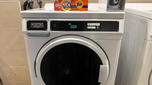 a washing machine with its door open in a kitchen at Holiday Inn Toronto International Airport by IHG in Toronto
