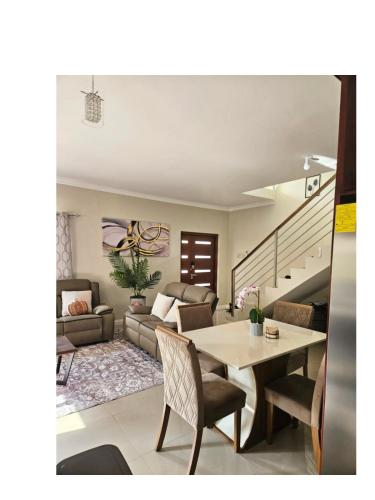 a living room with a table and a couch at Tranquility Loft in Ocho Rios