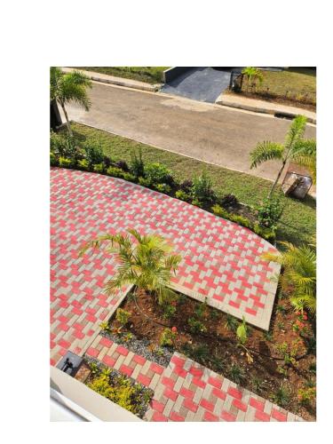 an overhead view of a walkway with palm trees on a sidewalk at Tranquility Loft in Ocho Rios