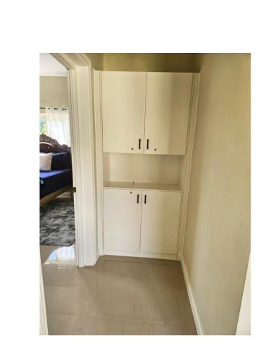 a living room with white cabinets in a room at Tranquility Loft in Ocho Rios