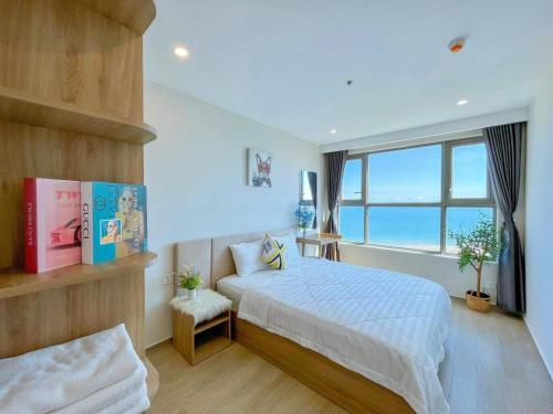 a bedroom with a bed and a large window at The Sóng Vũng Tàu Escape Apartment in Vung Tau