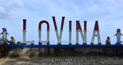 a sign that saysulumulum on top of a building at Lovina Garden Retreat in Lovina