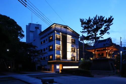 a building with a japanese building in front of it at Arima Royal Hotel in Kobe